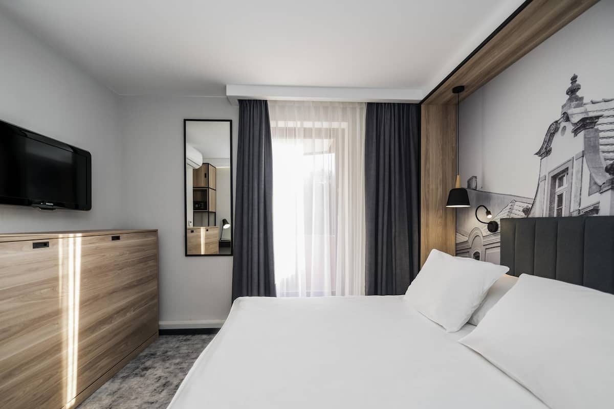 Hypo-allergenic bedding, desk, laptop workspace, blackout curtains