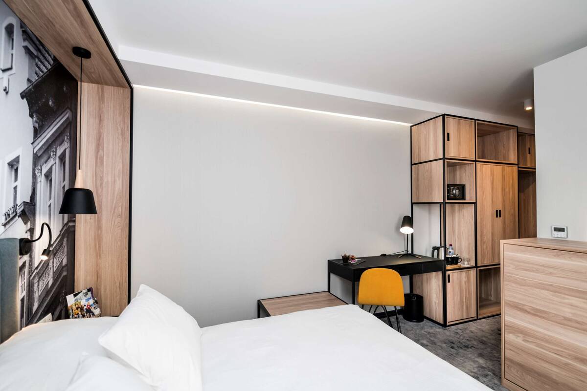 Hypo-allergenic bedding, desk, laptop workspace, blackout drapes