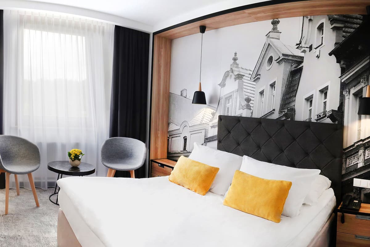 Hypo-allergenic bedding, desk, laptop workspace, blackout curtains