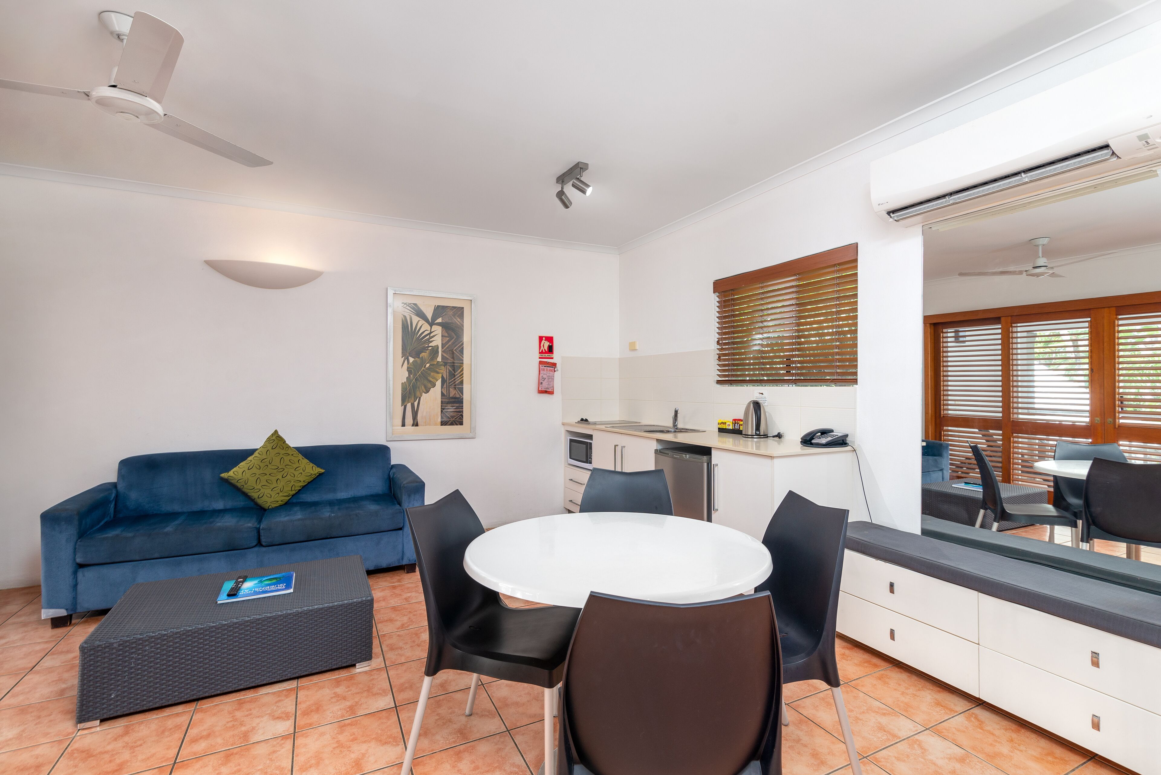 A compact living space with a kitchenette, a dining area, and a seating area.