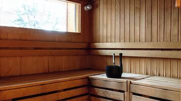 A sauna with wooden benches and a window.