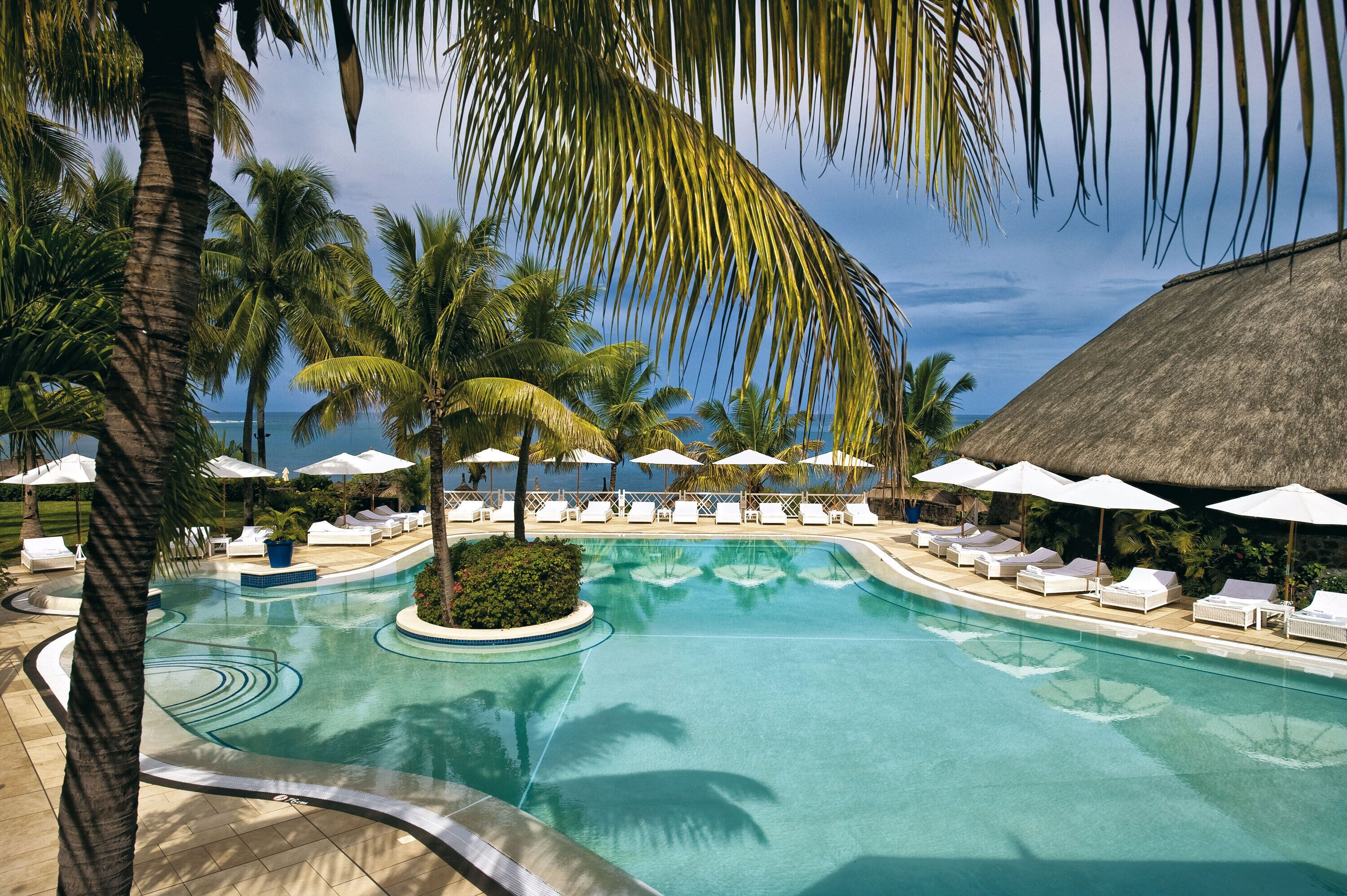 Outdoor pool, an infinity pool, pool umbrellas, pool loungers