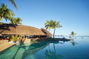 Outdoor pool, an infinity pool, pool umbrellas, sun loungers