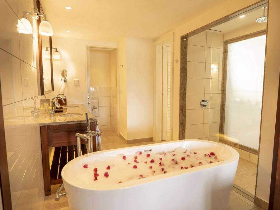 A modern bathroom with a freestanding bathtub, a double sink vanity, and a glass shower enclosure.