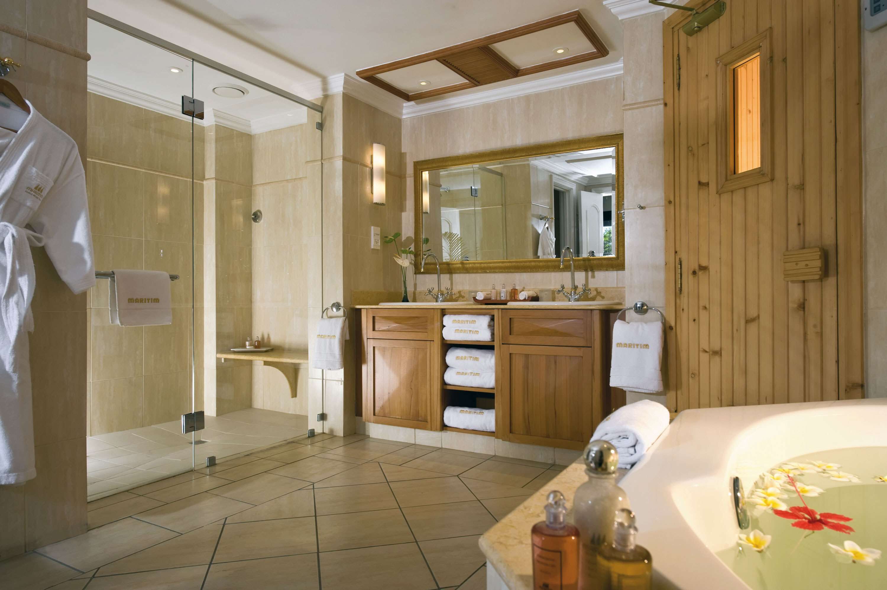 A modern bathroom with a large mirror, wooden cabinets, a shower, and a bathtub.