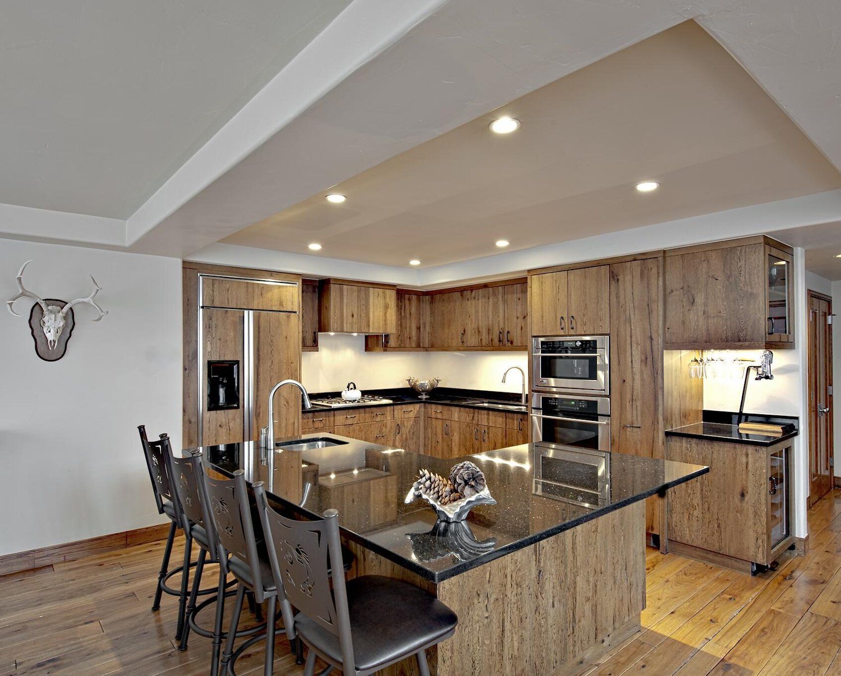 A modern kitchen with wooden cabinets, stainless steel appliances, and a central island.