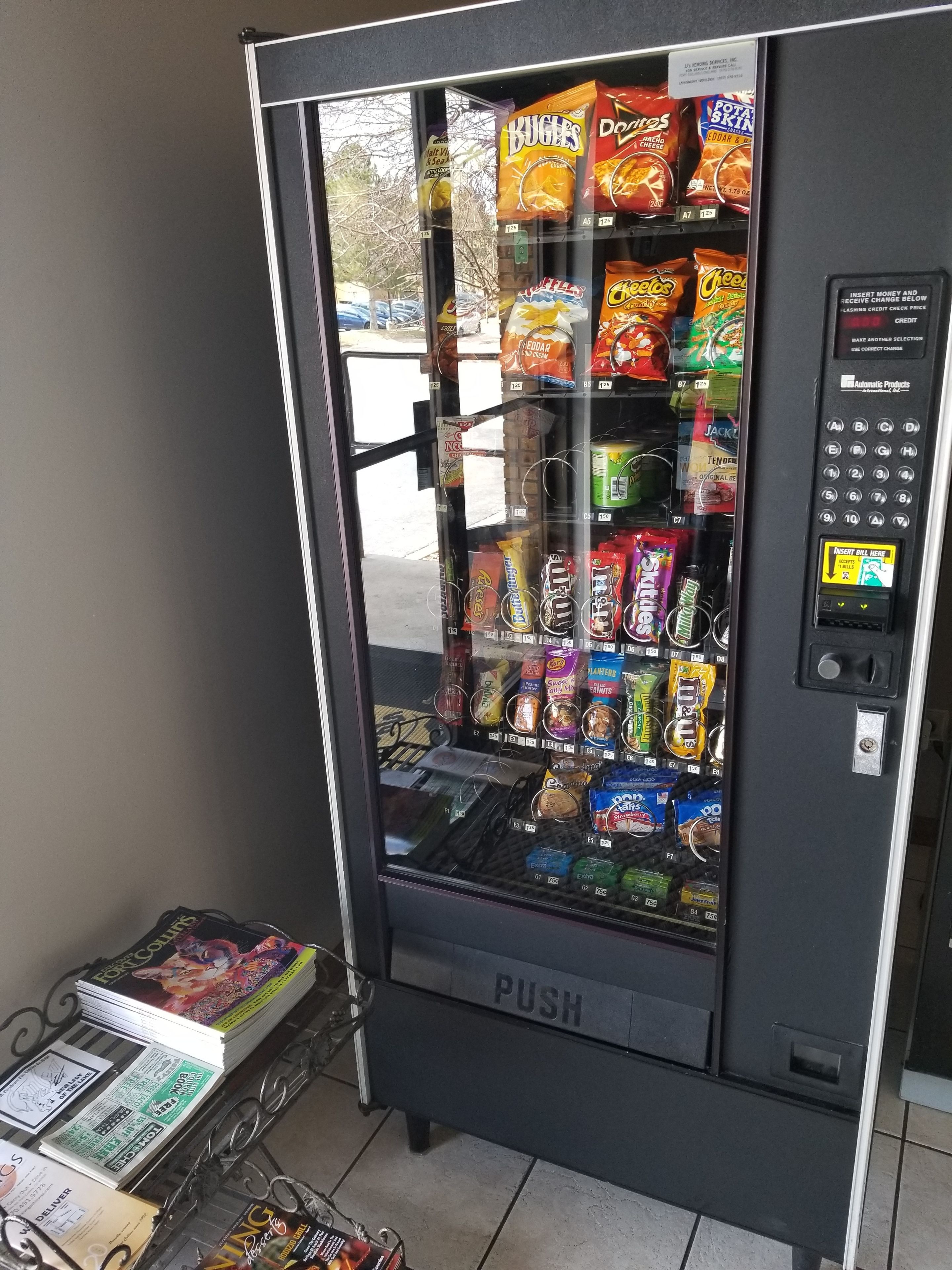 A vending machine with various snacks and drinks, a payment keypad, and a 'PUSH' button.