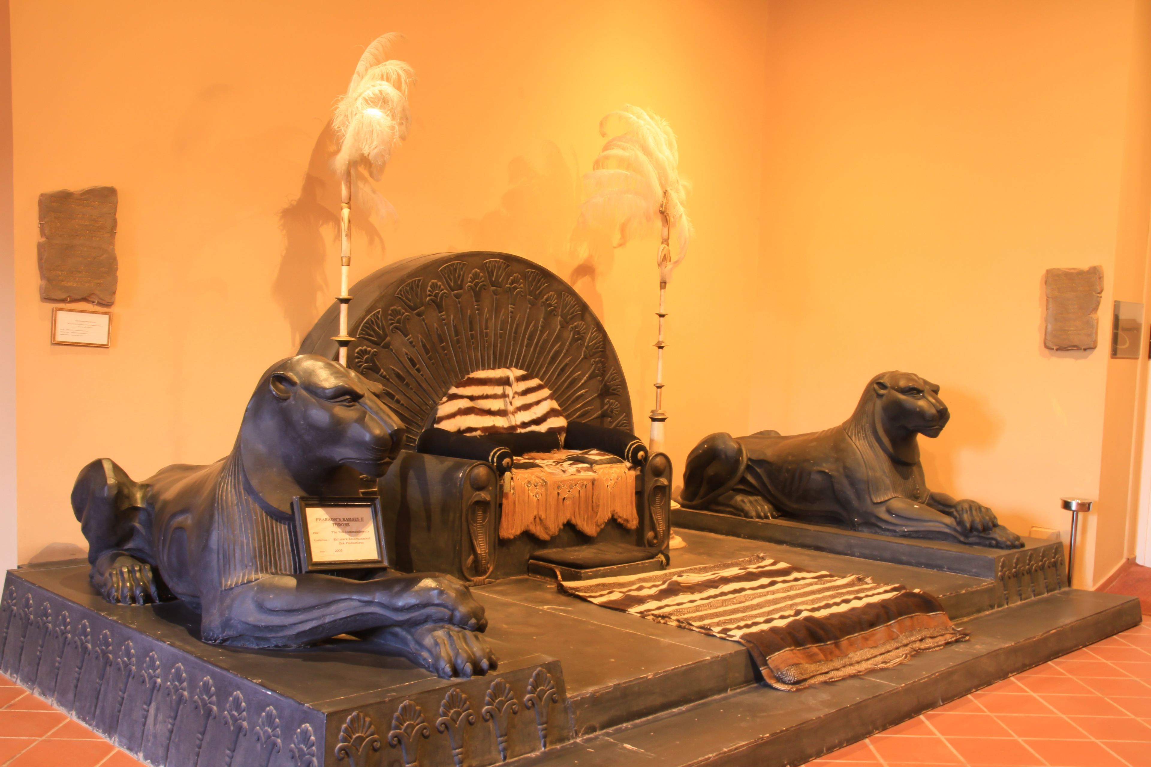 A statue of a seated figure with a throne, flanked by two lion statues.