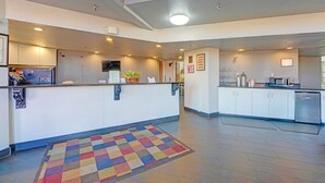 A modern kitchen with white cabinets, a microwave, and a sink. - Travelers inn by OYO Wichita Falls (Wichita Falls)
