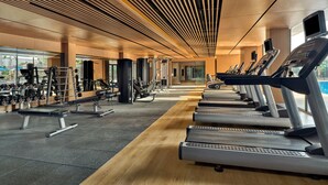 A modern gym with treadmills, weight machines, and dumbbells. - Shangri-La Shenzhen (Shenzhen)