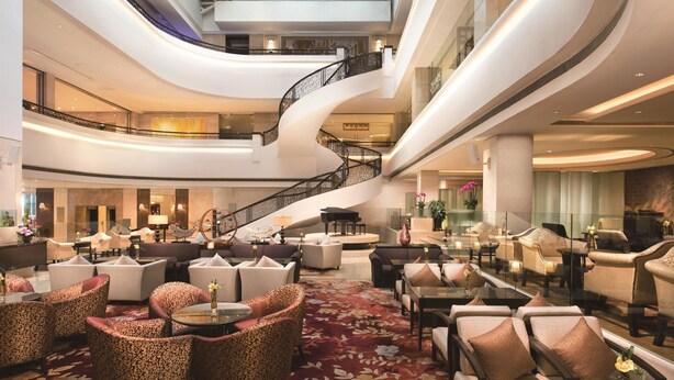 A spacious lobby with a grand staircase, multiple seating areas, and a large, ornate carpet. - Shangri-La Shenzhen (Shenzhen)