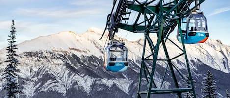 A cable car system with a mountainous backdrop.