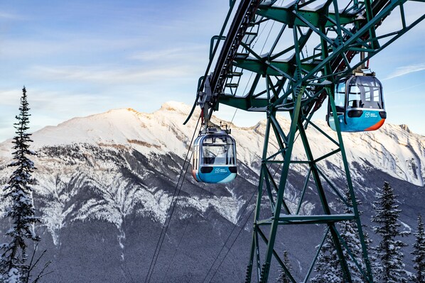 A cable car system with a mountainous backdrop.