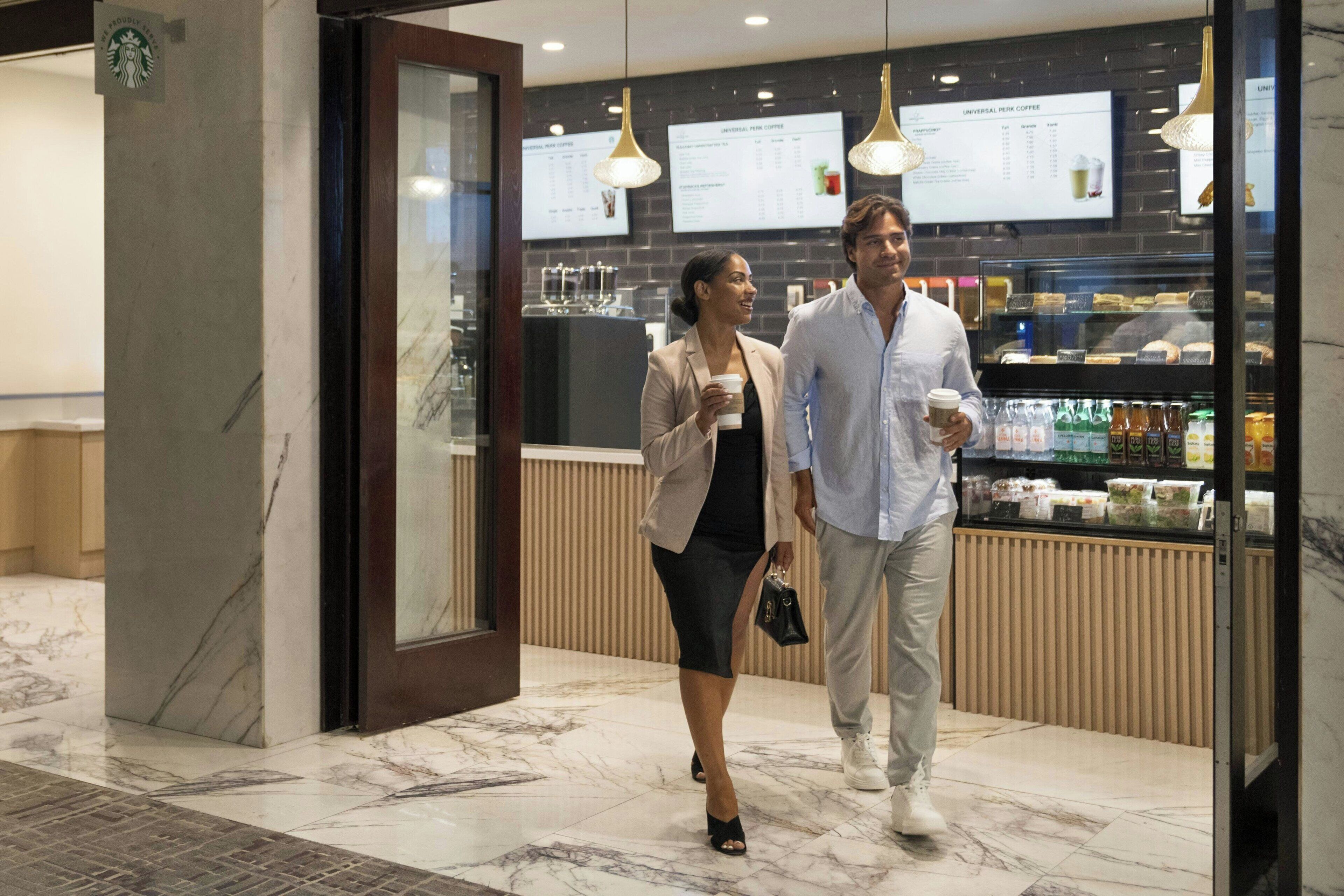 A Starbucks coffee shop with marble flooring and modern lighting fixtures.