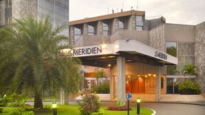 A hotel entrance with a modern design, featuring a prominent 'MERIDIEN' sign above the entrance. - Hotel Re-Ndama (Libreville)