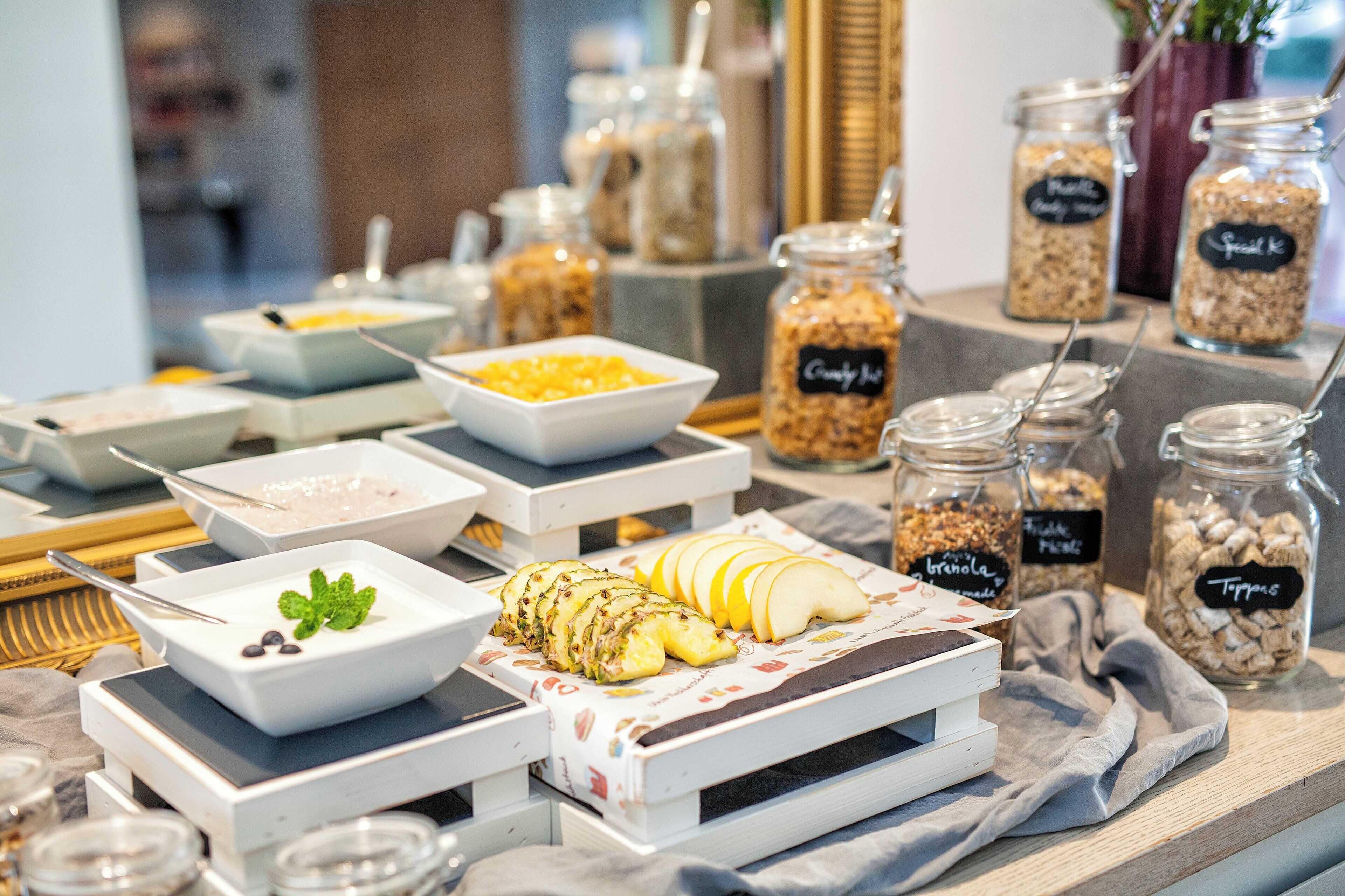 A buffet table with various food items and containers.