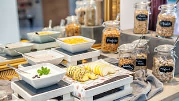 A buffet table with various food items and containers.
