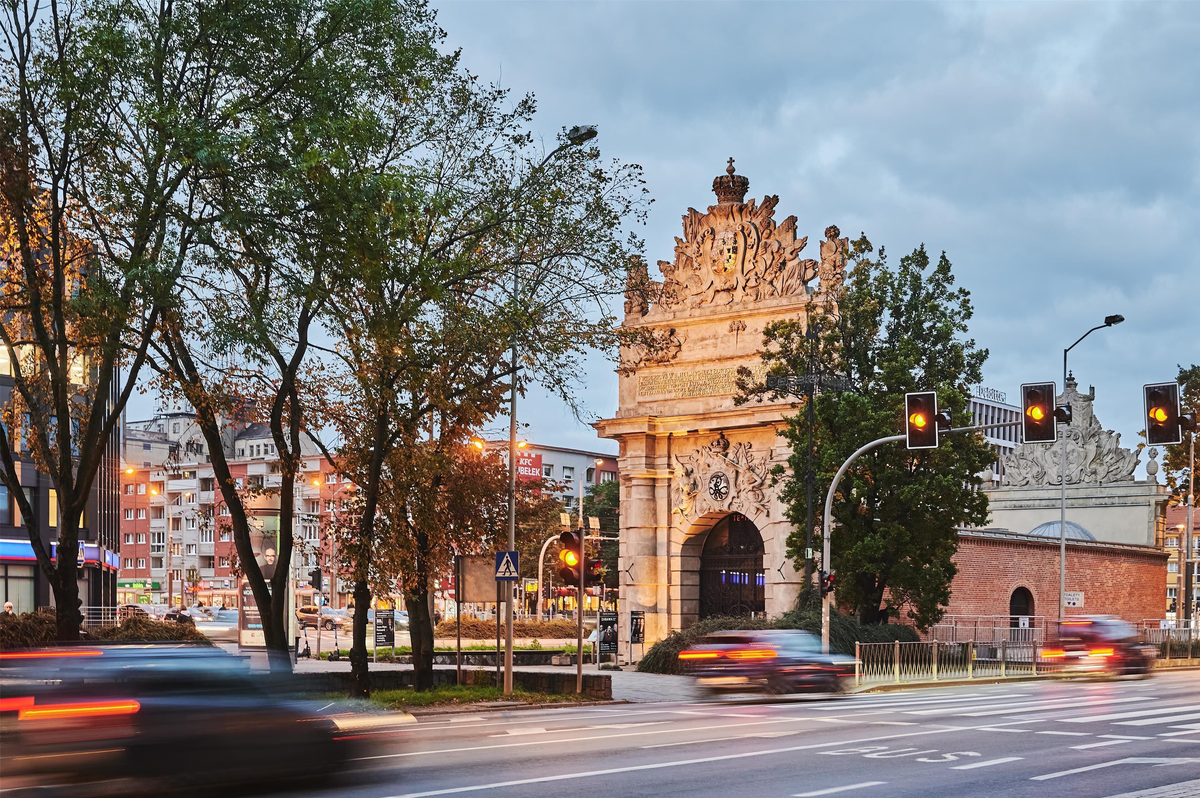 A historic building with ornate architecture and a large archway.