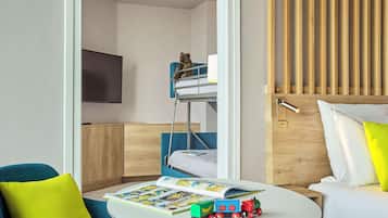 Cozy seating area with a comfortable armchair and a bunk bed, perfect for a family stay.