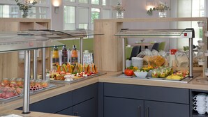 A buffet setup with various food items and condiments. - Hotel Stadt Hameln (Hamelin)