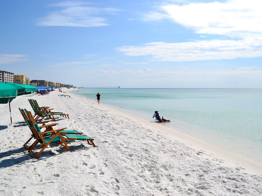 On the beach, white sand, sun loungers, beach umbrellas