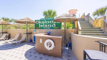 On the beach, white sand, sun loungers, beach umbrellas