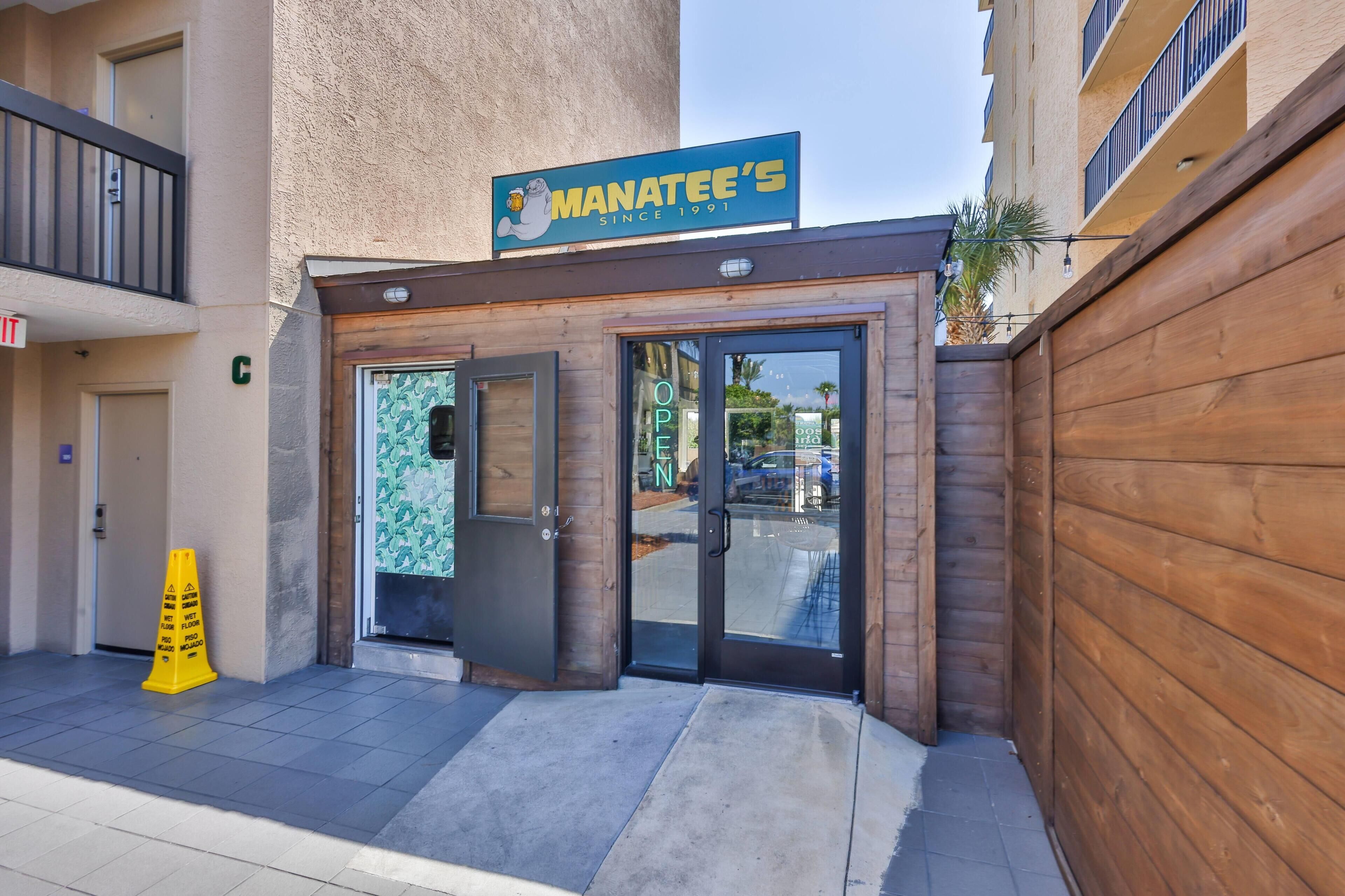 A restaurant named 'Manatee's' with a wooden facade and glass doors.