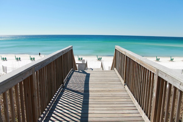 On the beach, white sand, sun-loungers, beach umbrellas