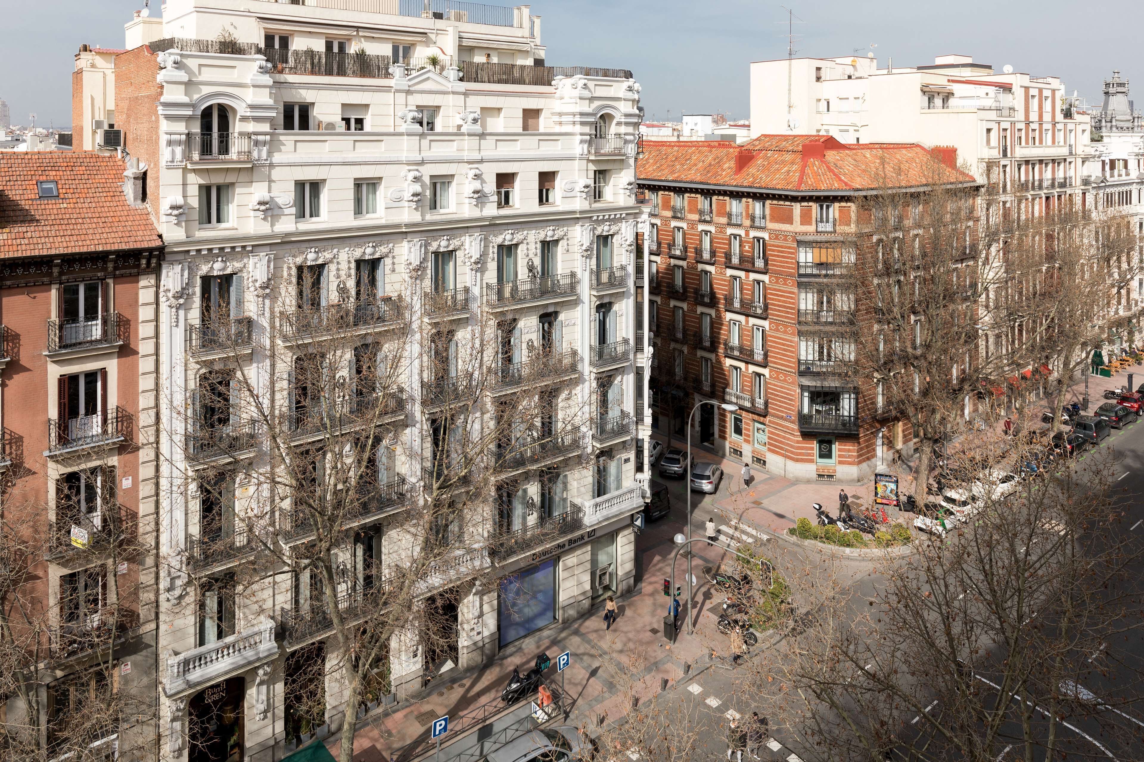 A multi-story building with a classic architectural style, featuring balconies and large windows.