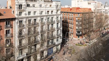 A multi-story building with a classic architectural style, featuring balconies and large windows.