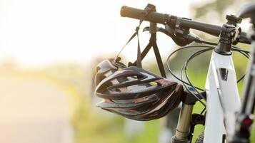 A bicycle with a front-mounted helmet and a rearview mirror.