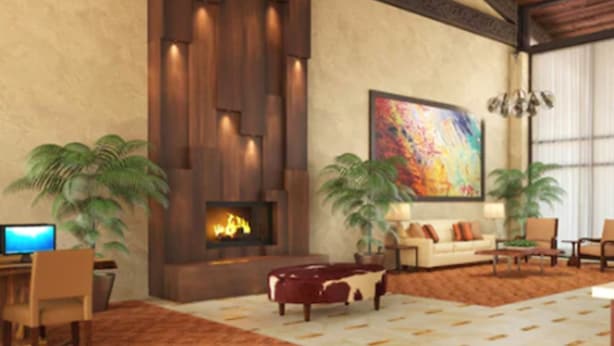 A spacious living room with a fireplace, a large abstract painting, and a modern sofa. - DoubleTree Suites by Hilton Tucson - Williams Center (Tucson)