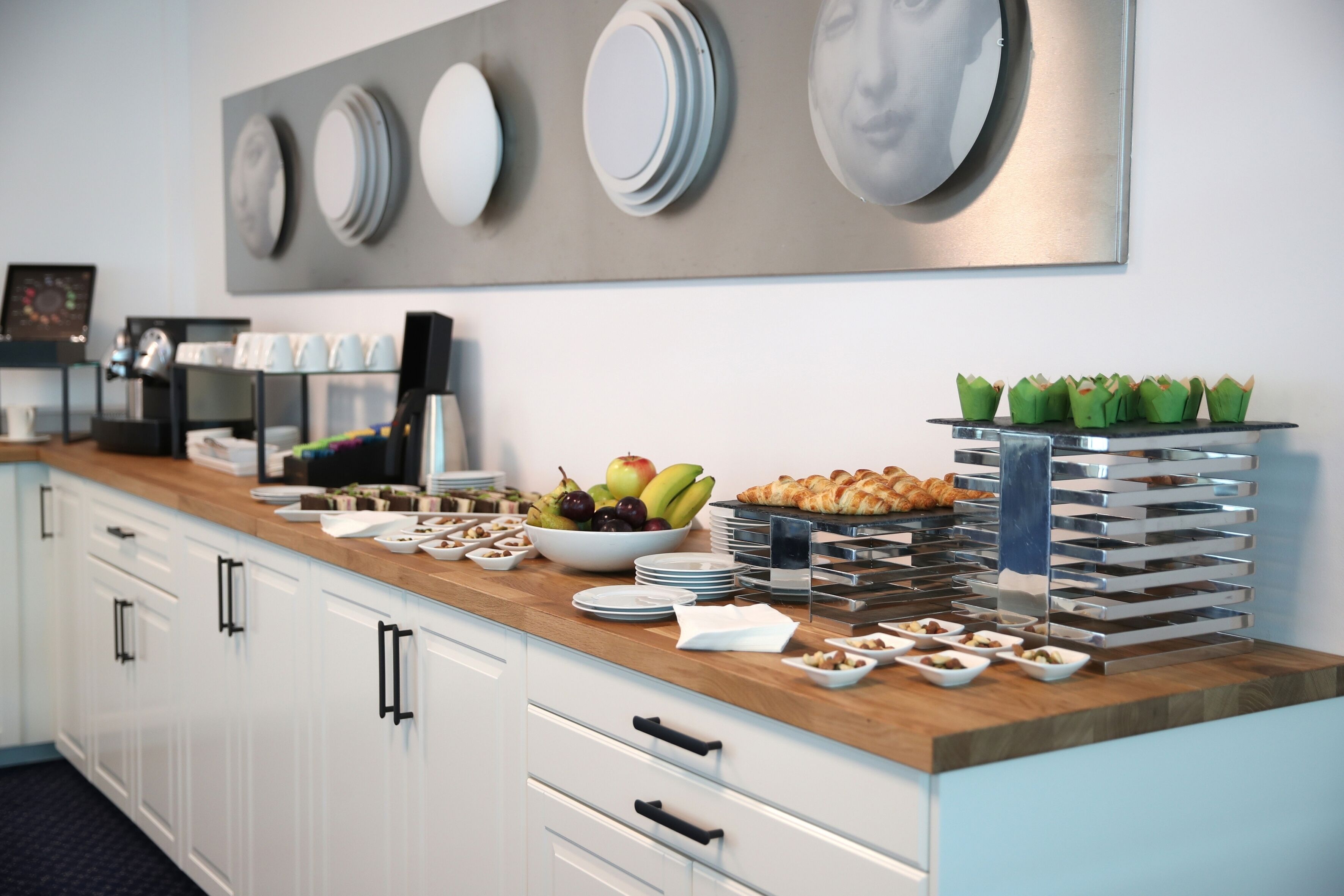 A buffet setup with various food items and a coffee station.