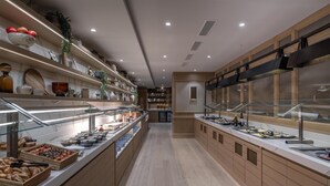 A modern buffet area with glass display cases, wooden cabinets, and a clean, well-lit interior. - Hilton Geneva Hotel and Conference Centre (Le Grand-Saconnex)