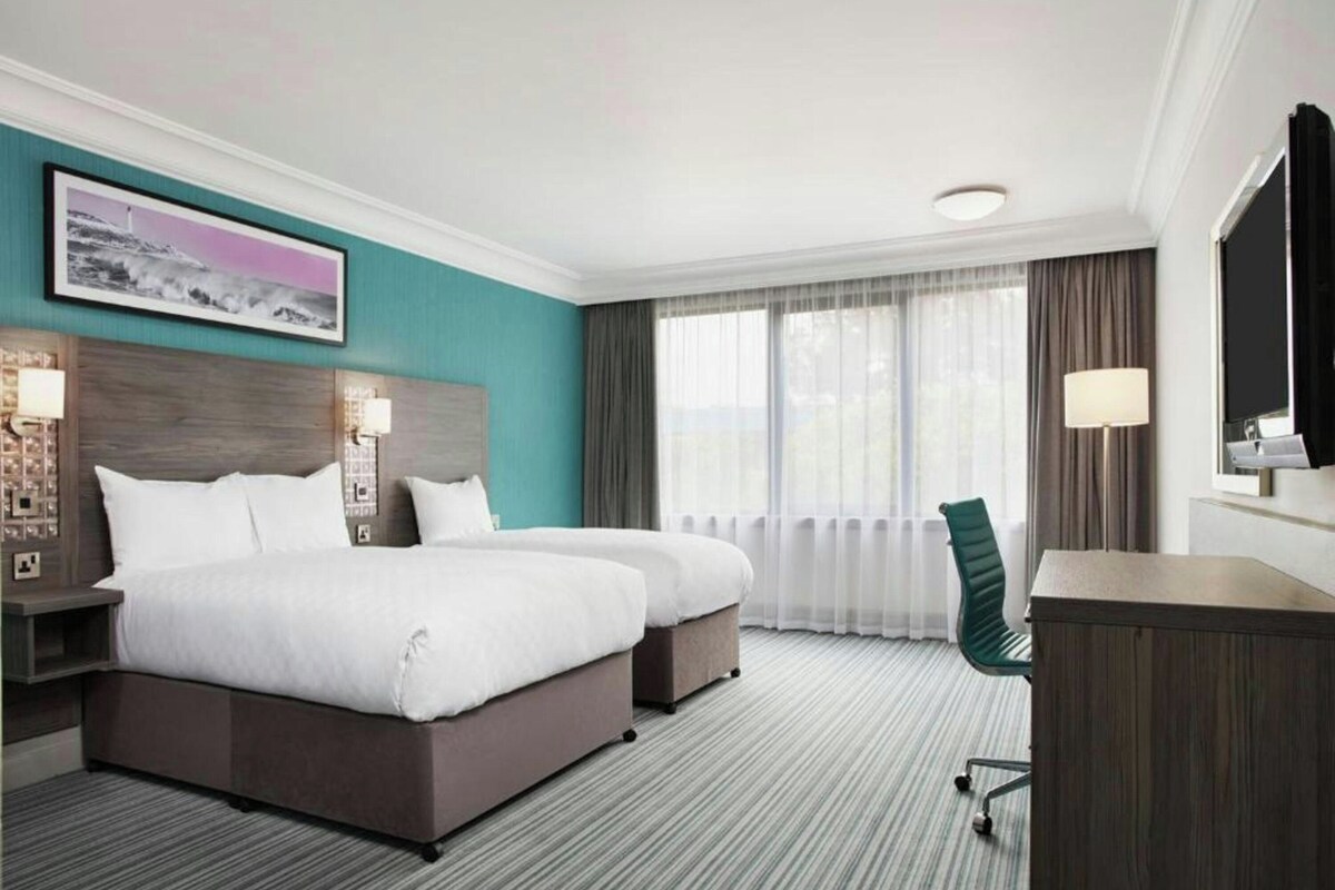 Premium bedding, desk, laptop workspace, soundproofing