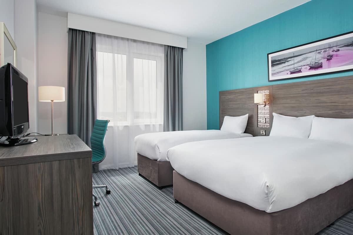 Premium bedding, desk, laptop workspace, soundproofing