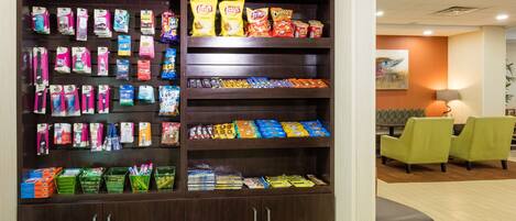 A snack display with various packaged foods and beverages.