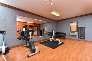 Stay fit and active in this well-equipped gym with a stationary bike, bench press, rowing machine, and dumbbells.