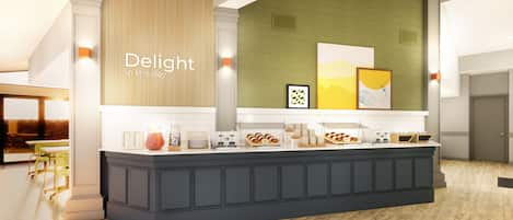 A modern reception area with a counter displaying various amenities, a wall with vertical wooden slats, and framed artwork.