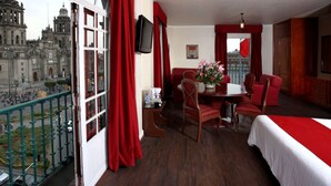 A hotel room with a balcony, a dining area, and a bed. - Best Western Majestic (Mexico City)