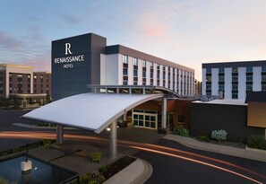 A modern hotel with a prominent 'Renaissance Hotel' sign, a covered walkway, and a landscaped area with a water feature. - Renaissance Minneapolis Bloomington Hotel (Bloomington)