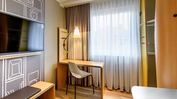 Relax in a stylish room with a flat-screen TV, desk, and large window offering a view.