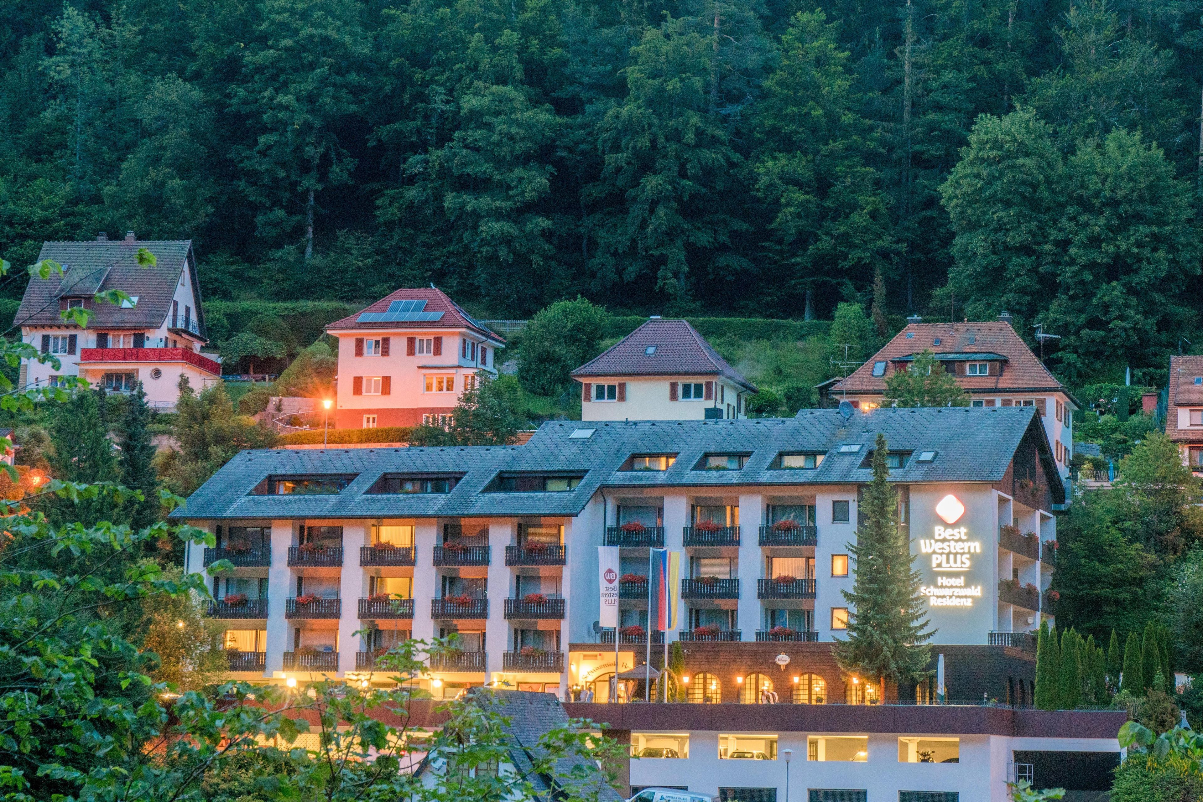 A hotel with multiple floors, balconies, and a sign indicating it is a Best Western PLUS hotel.