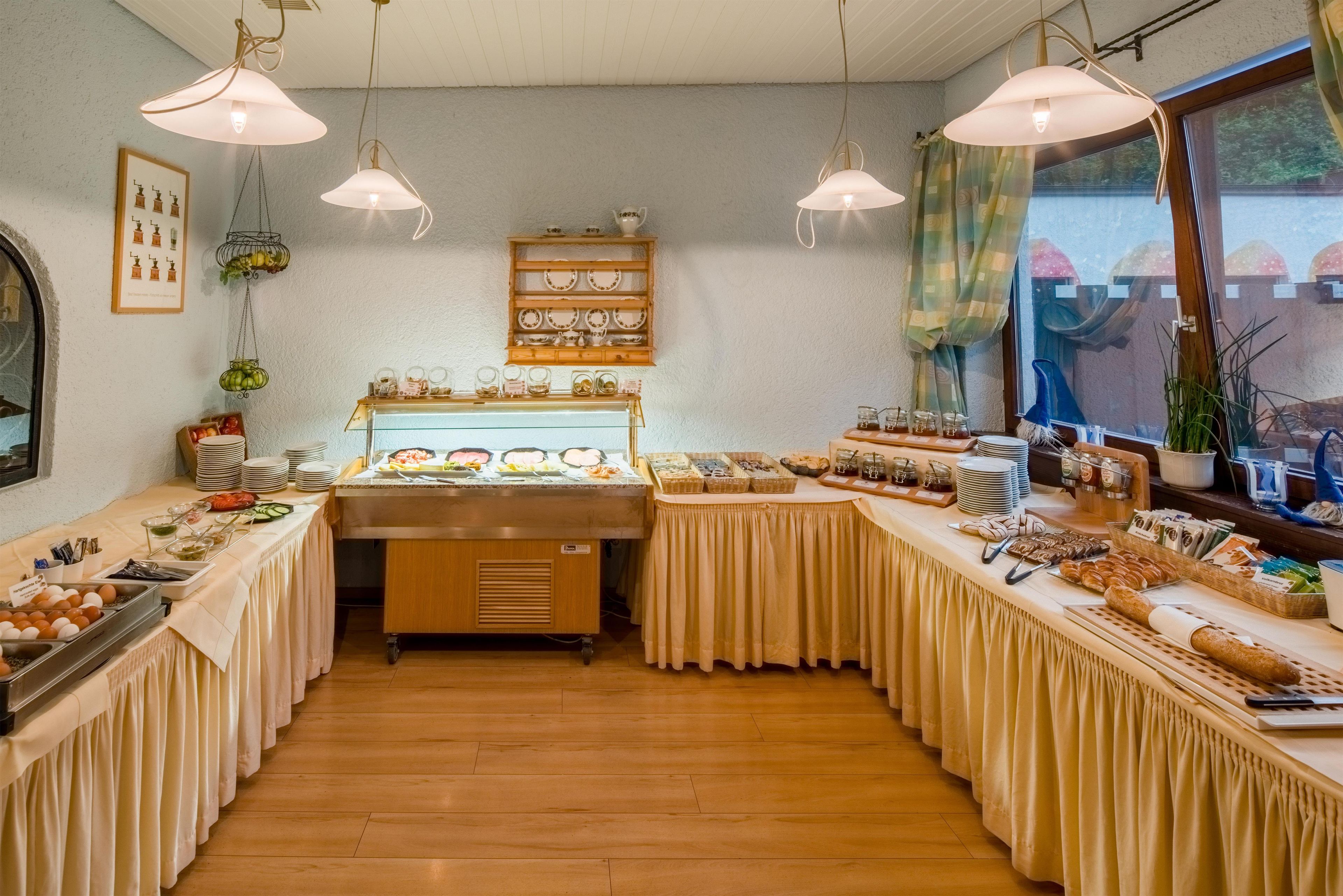 A buffet setup with various food items and a display case in the center.
