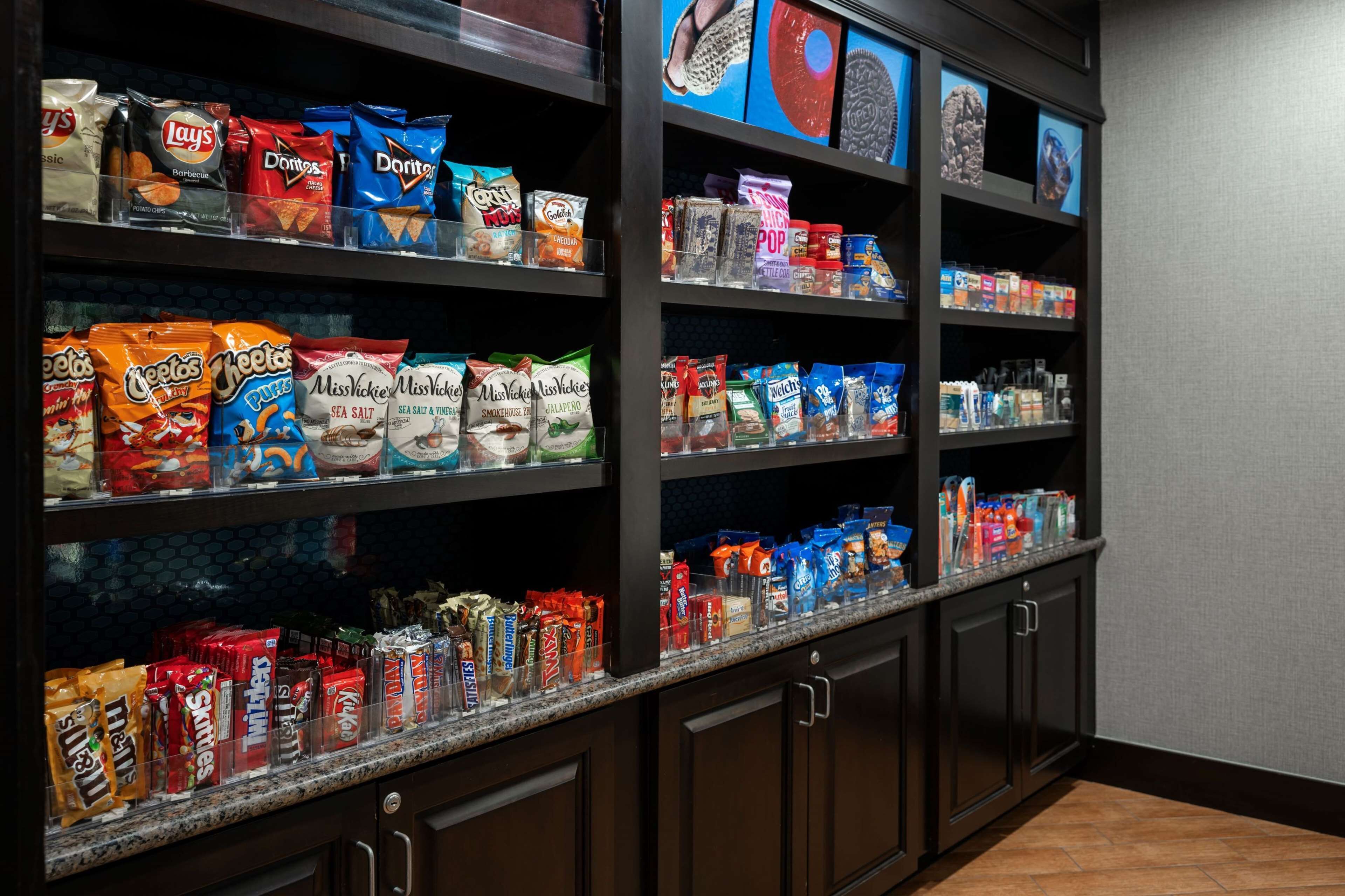 A snack display with various chips and candies.