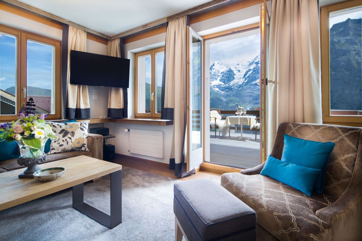 one bedroom suite with eiger montain view | living area | 30-inch flat-screen tv with cable channels
