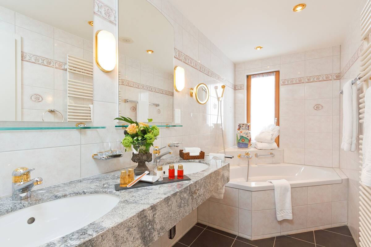 one bedroom suite with eiger montain view | bathroom | hair dryer, bathrobes, slippers, towels