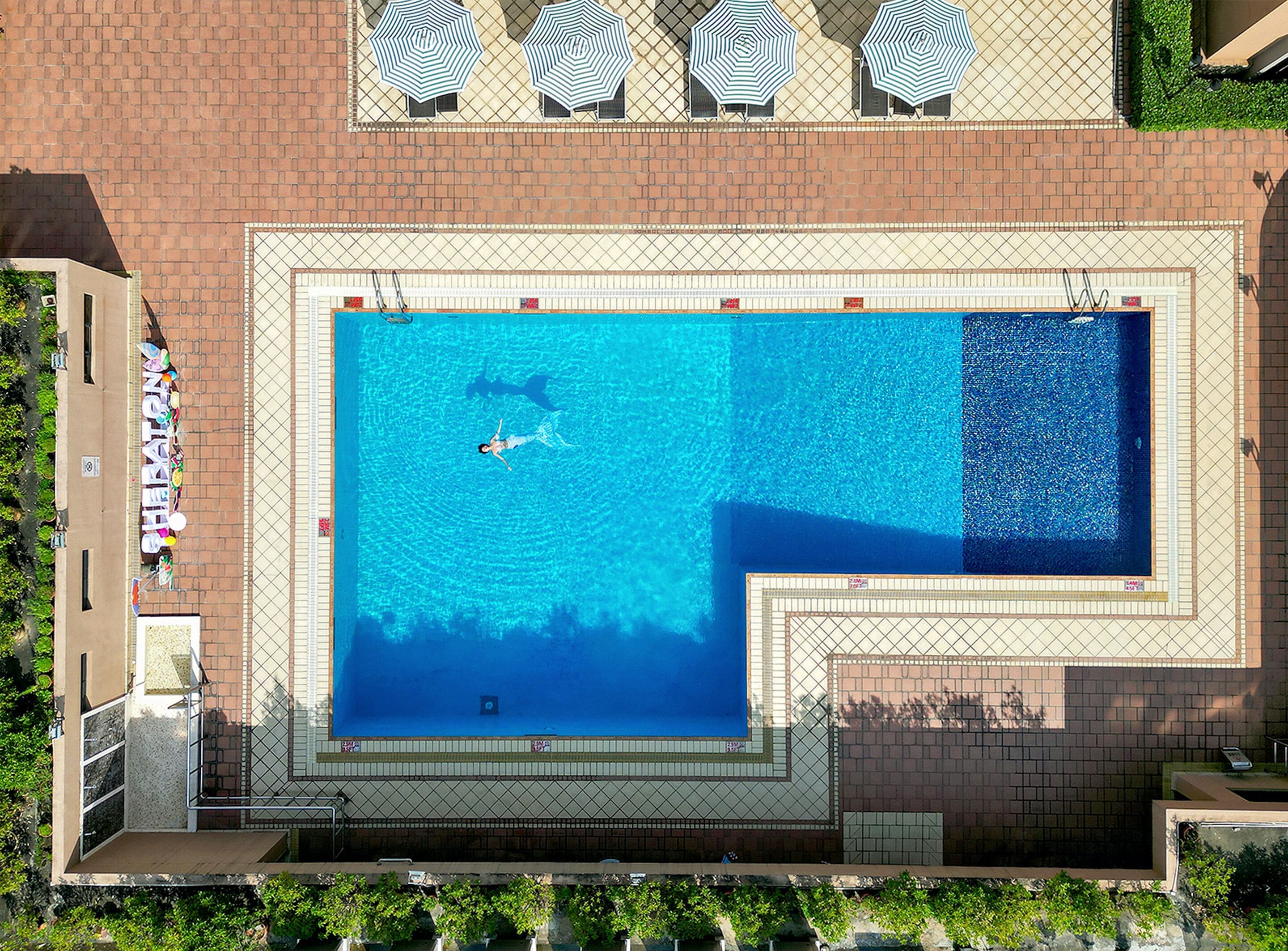 outdoor pool, open 6:00 am to 11:00 pm, pool umbrellas