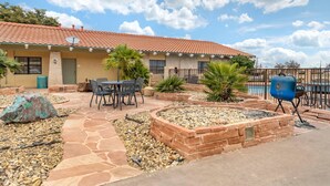 A patio with stone flooring, a barbecue grill, and outdoor furniture. - Quality Inn San Angelo (San Angelo)