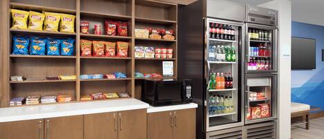 A snack and beverage vending area with various snack options and drinks.